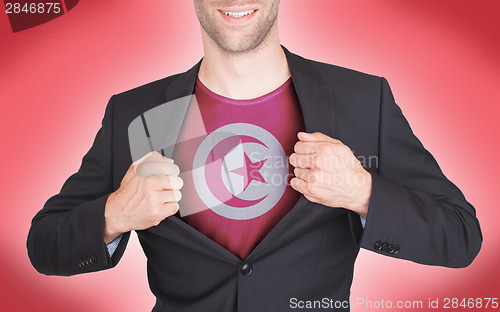 Image of Businessman opening suit to reveal shirt with flag