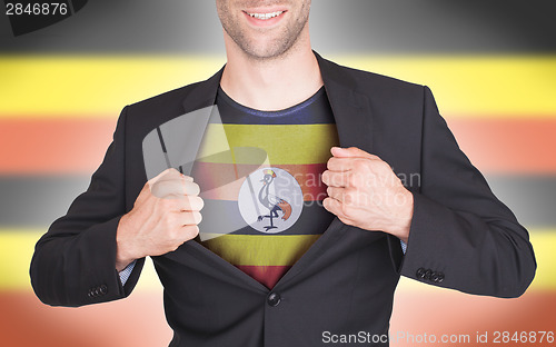 Image of Businessman opening suit to reveal shirt with flag