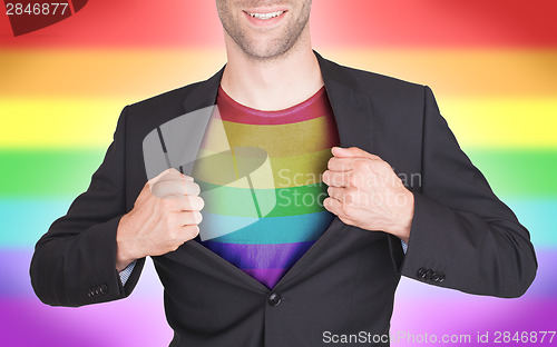 Image of Businessman opening suit to reveal shirt with flag