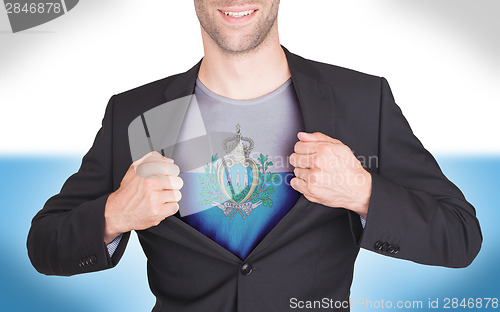 Image of Businessman opening suit to reveal shirt with flag