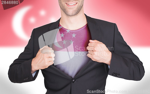 Image of Businessman opening suit to reveal shirt with flag