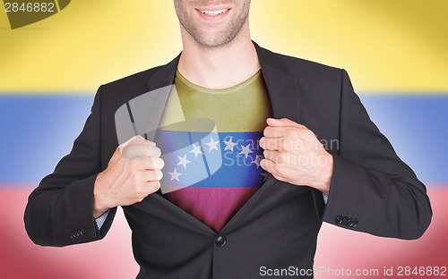 Image of Businessman opening suit to reveal shirt with flag