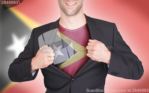 Image of Businessman opening suit to reveal shirt with flag