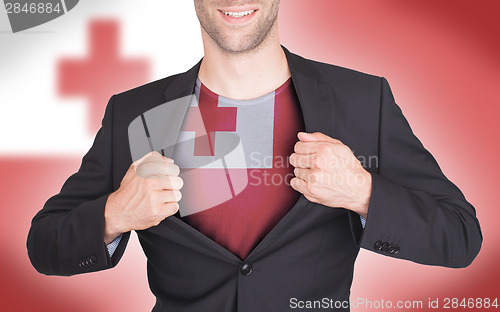 Image of Businessman opening suit to reveal shirt with flag