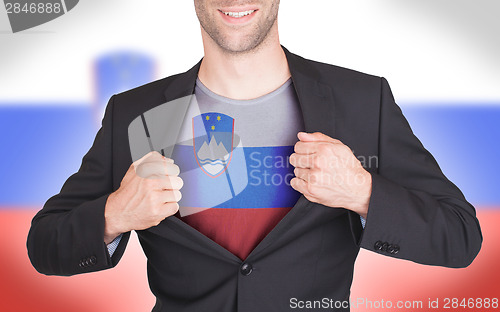 Image of Businessman opening suit to reveal shirt with flag