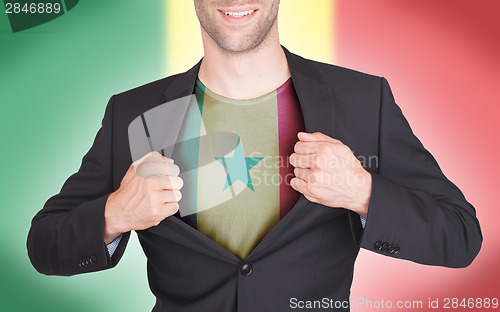 Image of Businessman opening suit to reveal shirt with flag