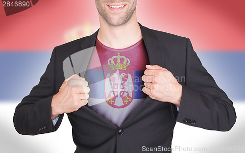 Image of Businessman opening suit to reveal shirt with flag