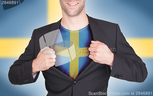 Image of Businessman opening suit to reveal shirt with flag