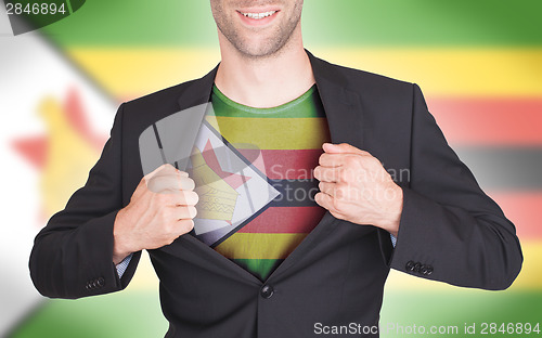 Image of Businessman opening suit to reveal shirt with flag