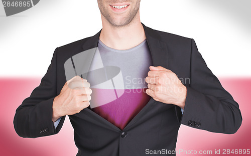 Image of Businessman opening suit to reveal shirt with flag