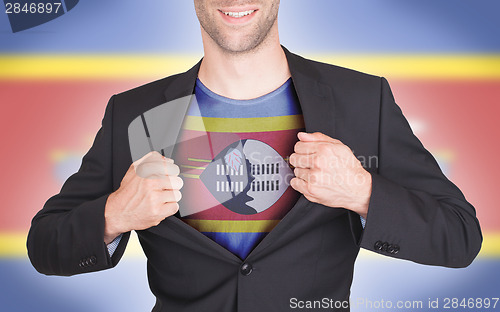 Image of Businessman opening suit to reveal shirt with flag