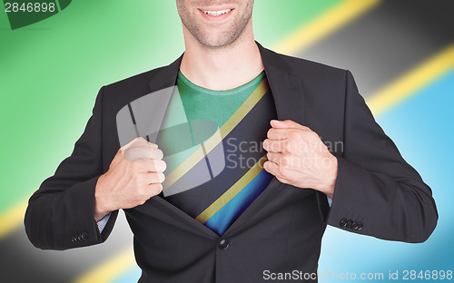 Image of Businessman opening suit to reveal shirt with flag