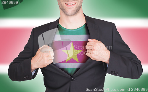 Image of Businessman opening suit to reveal shirt with flag
