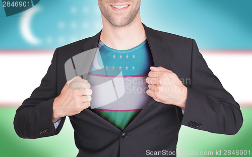 Image of Businessman opening suit to reveal shirt with flag