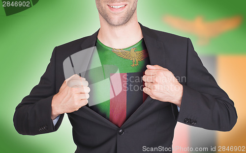 Image of Businessman opening suit to reveal shirt with flag