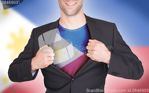 Image of Businessman opening suit to reveal shirt with flag