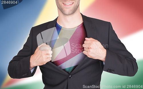 Image of Businessman opening suit to reveal shirt with flag