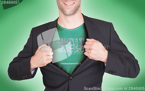 Image of Businessman opening suit to reveal shirt with flag