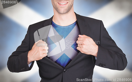 Image of Businessman opening suit to reveal shirt with flag