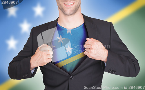 Image of Businessman opening suit to reveal shirt with flag