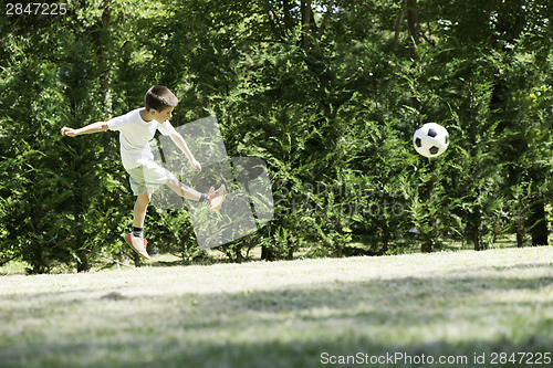 Image of Child playing football in a stadium