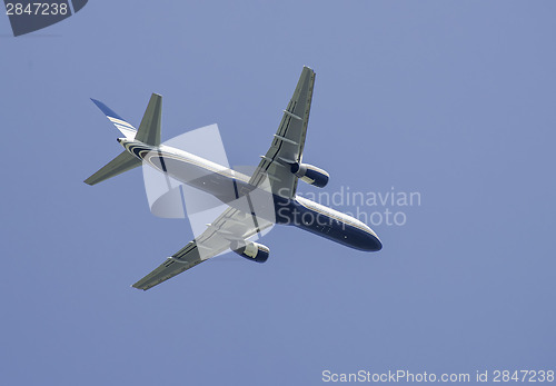 Image of Flying plane on blue sky background