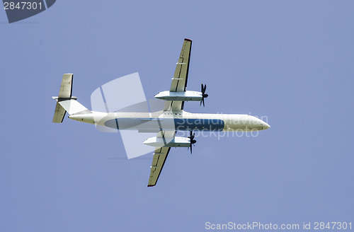 Image of Flying plane on blue sky background