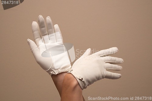 Image of woman modeling formal vintage gloves with small buckles