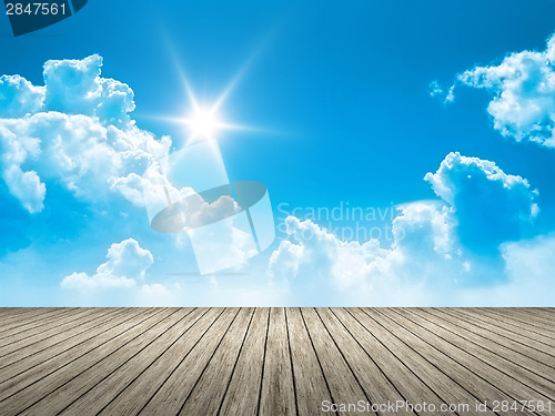 Image of wooden jetty blue sky sun