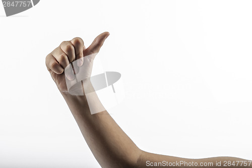 Image of Young hand make hitchhiking gesture