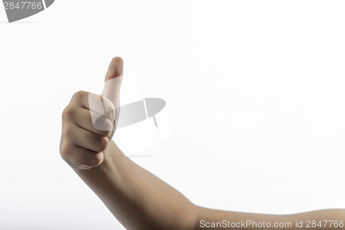 Image of Young hand make hitchhiking gesture