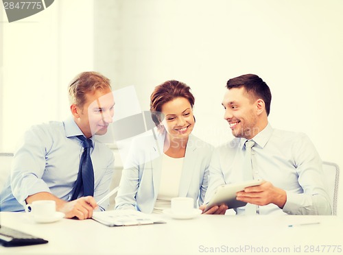 Image of business team having fun with tablet pc in office