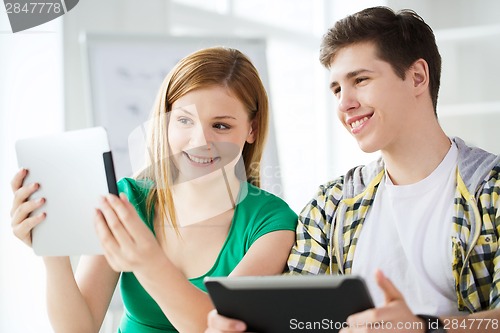 Image of smiling students with tablet pc at school