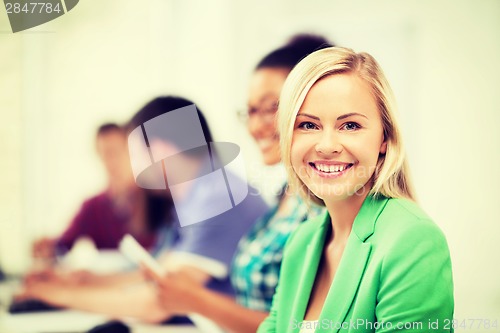 Image of students with computers studying at school