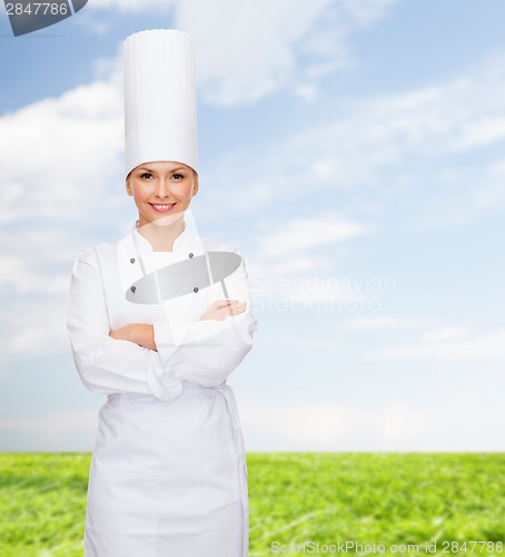 Image of smiling female chef with crossed arms