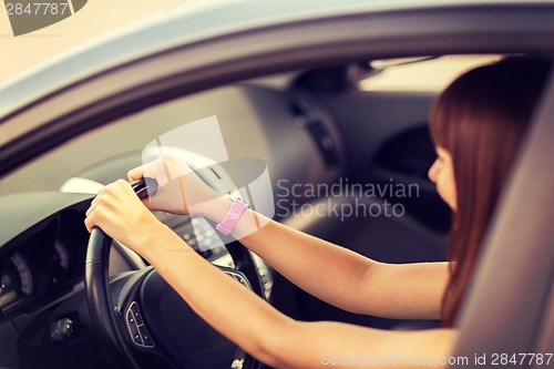 Image of happy woman driving a car