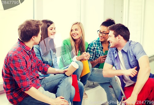 Image of students communicating and laughing at school