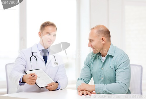 Image of doctor with clipboard and patient in hospital