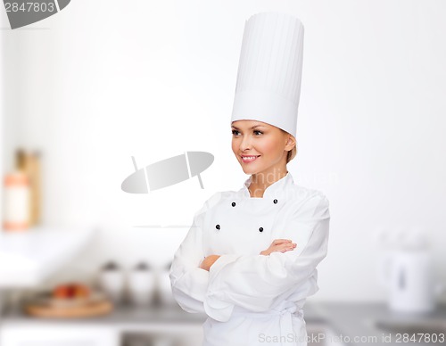 Image of smiling female chef with crossed arms