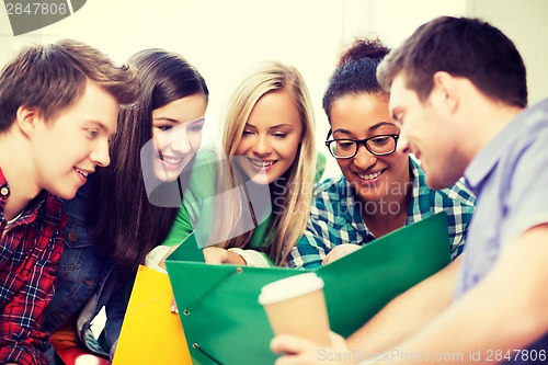 Image of students looking at notebook at school