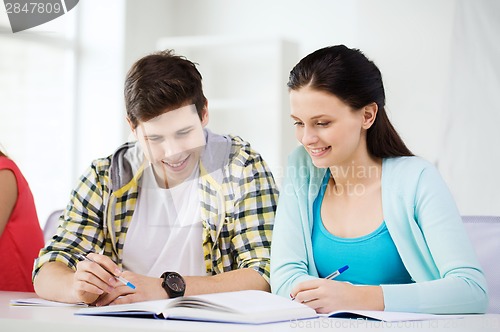 Image of students with textbooks and books at school