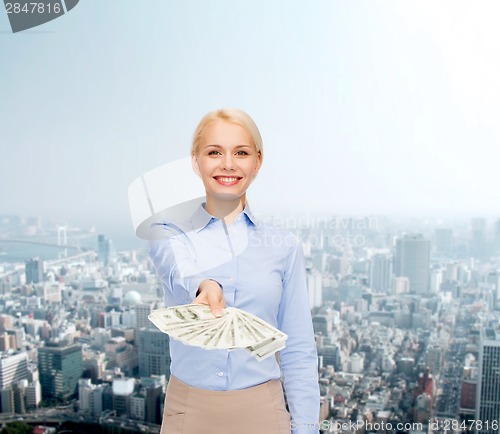 Image of young businesswoman with dollar cash money