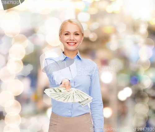 Image of young businesswoman with dollar cash money