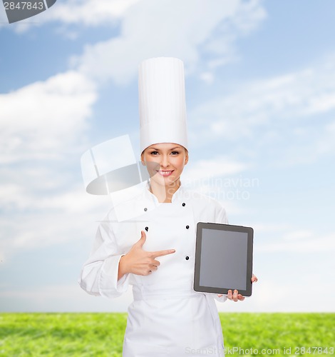 Image of smiling female chef with tablet pc blank screen