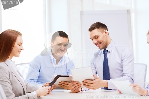 Image of business team working with tablet pc in office