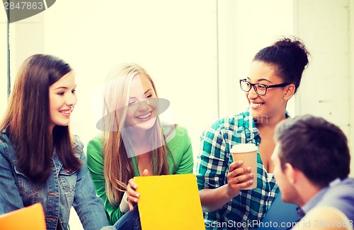 Image of students communicating and laughing at school