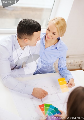 Image of couple looking at blueprint and color samples