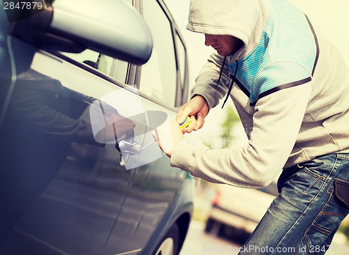 Image of thief breaking the car lock