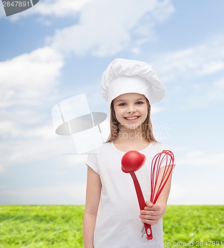 Image of smiling girl in cook hat with ladle and whisk