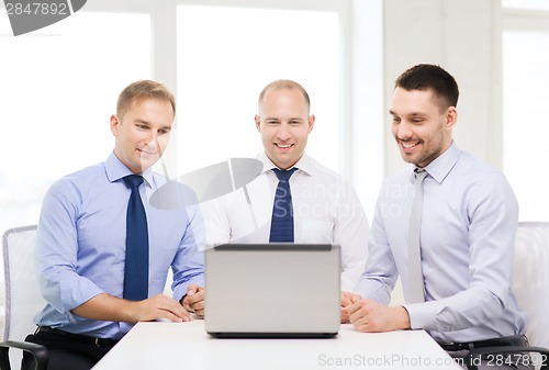 Image of business team working with laptop in office